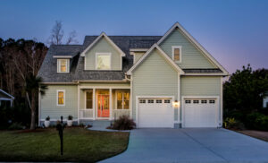 A beautiful olive green two-story house with stone fencing in California, representing property value used for second mortgages.